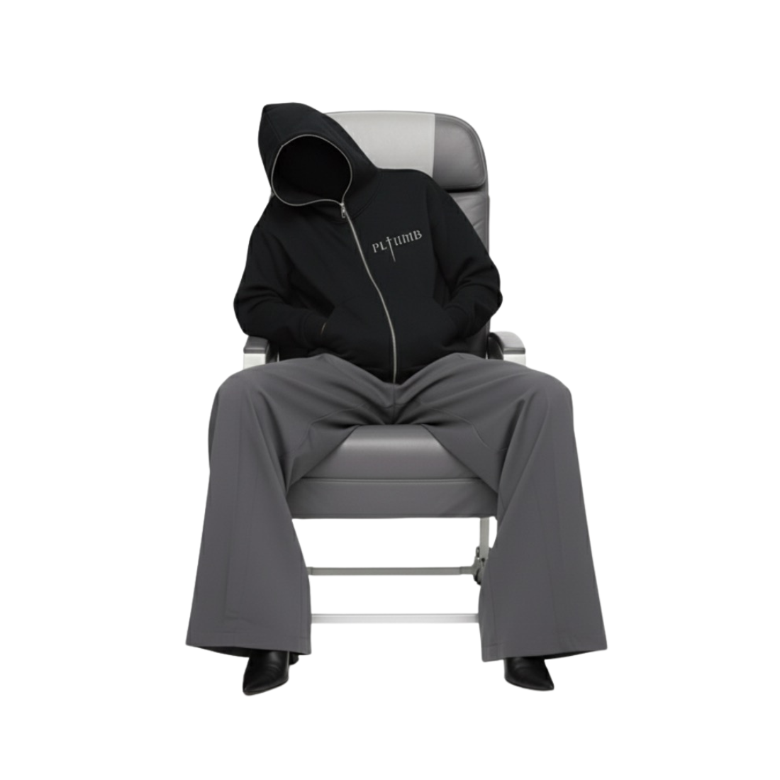 Vicki Holland wearing a ATELIER FULL-ZIP BOXY HOODIE gray Maison Margiela pants sitting on a gray commercial airline chair