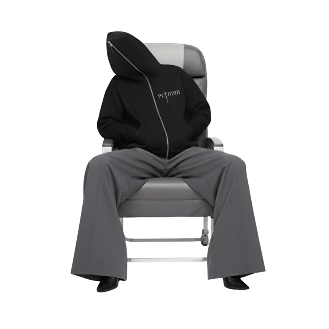 Vicki Holland wearing a ATELIER FULL-ZIP BOXY HOODIE gray Maison Margiela pants sitting on a gray commercial airline chair